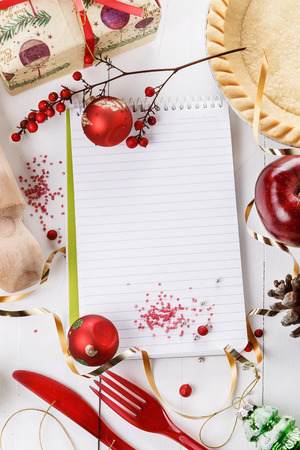 Charismas baking concept. Tart base, utensils, apples and Christmas objects over white wooden background. Top viewの写真素材