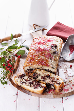 Sliced cranberry loaf on a wooden tray over white wooden backgroundの写真素材