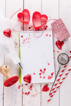 Valentine day baking concept with heart shaped cookie cutters, chocolate hearts and kitchen tool. Top view, Copy spaceの写真素材