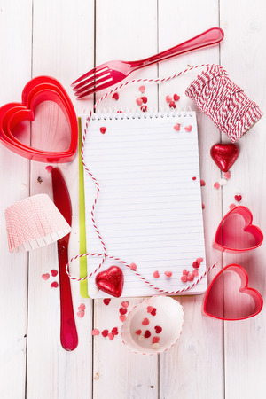 Valentine day baking concept with heart shaped cookie cutters, chocolate hearts and kitchen twine and tool. Top view, Copy spaceの写真素材
