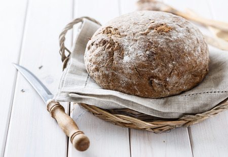 Freshly baked rye sourdough bread on white wooden background. の写真素材