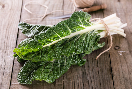 Bunch of organic silverbeet on a rustic wooden background. Selective focus, shallow depth of fieldの写真素材