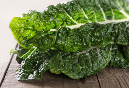 Macro view of organic silverbeet leaves on a rustic wooden background. Selective focus, shallow dofの写真素材