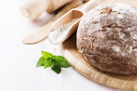 Freshly baked rye sourdough bread on white wooden background. Selective focus, shallow depth of field, Copy spaceの写真素材