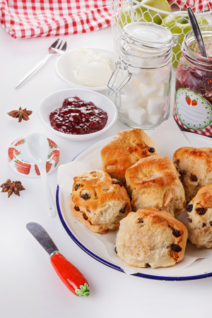 Freshly baked sconces, jam and cream over white backgroundの写真素材