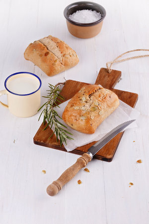 Ciabatta bread and rosemary on a rustic wooden backgroundの写真素材