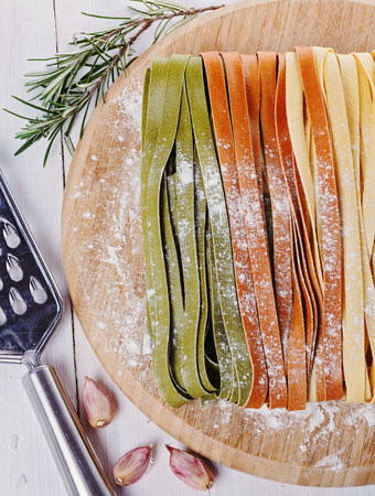 Colorful fettuccine over white wooden backgroundの写真素材