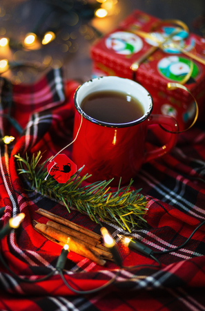 Christmas themed image with cup of tea and Christmas lights. Selective focus, shallow depth of field, bokehの写真素材