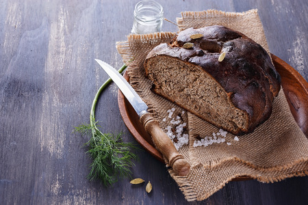 Yeast free rye bread with spices on a rustic wooden backgroundの写真素材
