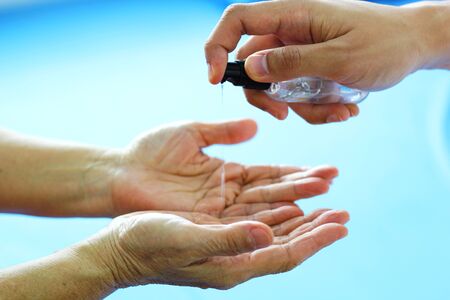 Clean hands with alcohol gel. To prevent the virus, Covid-19.の写真素材