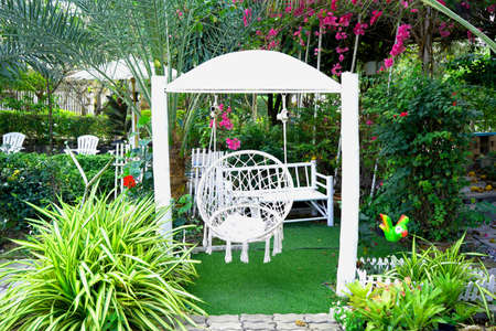 White hanging mesh chair hammock in the garden. for sitting and relaxing outdoors.の写真素材