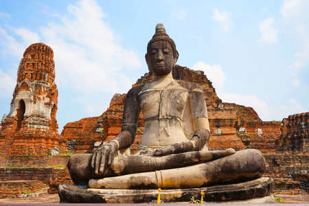 Buddha image in front of the main pagoda of Wat Mahathat Ayutthaya Historical Park, Thailand.の写真素材