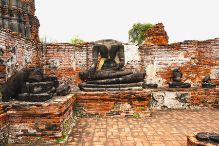 Ruins of sandstone Buddha statues at Wat Mahathat Ayutthaya Historical Park.の写真素材