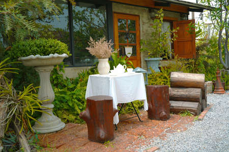 Decorate the garden with coffee sets on white cloth-covered tables and stump chairs.の写真素材