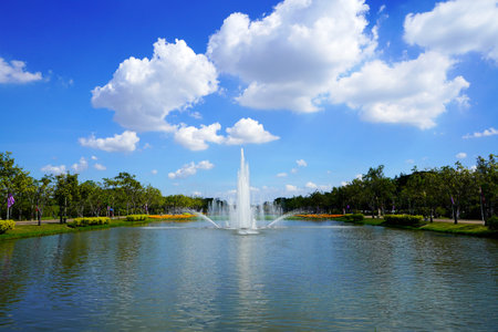 Beautiful outdoor fountain in the middle of a pond at the park.の写真素材