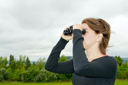 Woman with binocularsの写真素材