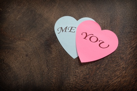 Heart shaped post its on wooden backgroundの写真素材