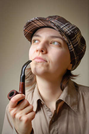 Young nicotine addict woman smoking a pipeの写真素材