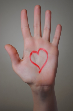 Red heart shape drawn on womanの写真素材