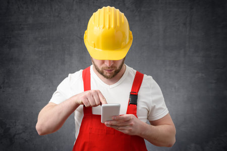 Construction worker using smartphone