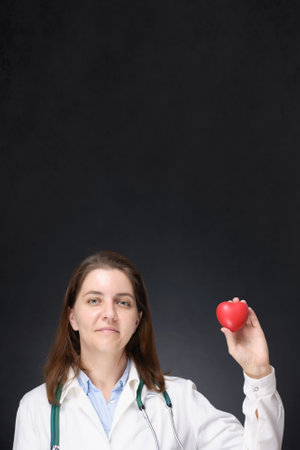 Doctor holding a red heart shapeの写真素材