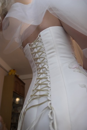 The brides corset in a white long wedding dressの写真素材