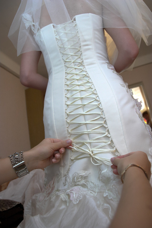Friend of the bride bride corset laces on a wedding dressの写真素材