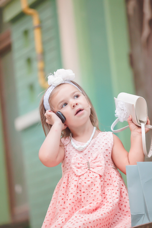 Smartphone is held by child near ear.の写真素材