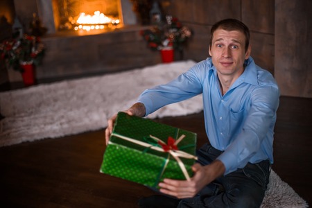 Man gives gift in the green box. Shopping for Christmas.の写真素材