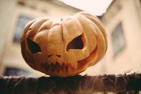 Halloween symbol pumpkin smiling jack-o-lantern on house background, horizontal, copyspaceの写真素材