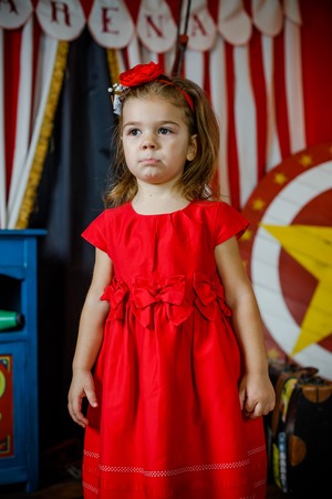 Offended child did not receive gifts. Girl in a circus tent.の写真素材