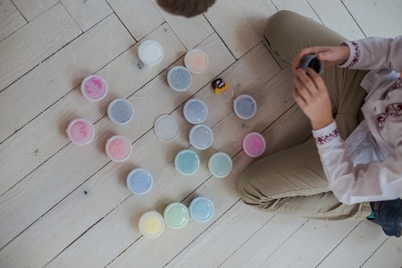 Two brothers play together. Children mold homemade from stiffening clay. Fun at home. Simple figures from plasticine do it yourself.の写真素材