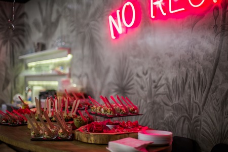 Buffet at party. quick snacks on the buffet table. Dishes with chopped meat and vegetables. Lumiere in the bar. Food at party.の写真素材