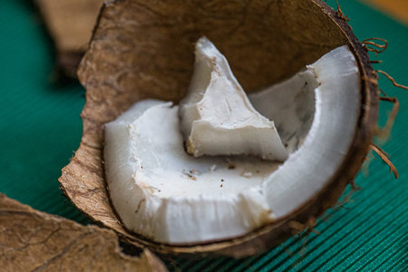 ugly organic broken rotten coconut. peel and white insides of a moldy coconut. Spoiled foods.