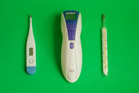 Text BEST Thermometer for home. Three different types of thermometers on green background. mercury,...