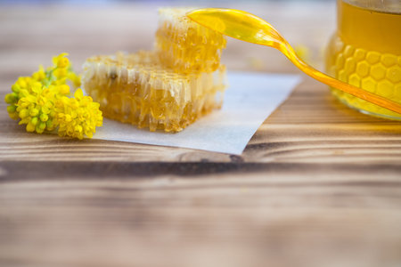 broken yellow honeycomb with honey on table. Honey products. healthy natural food concept