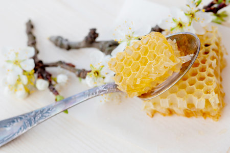 broken yellow honeycomb with honey on table. Honey products. healthy natural food concept. Copy spaceの写真素材