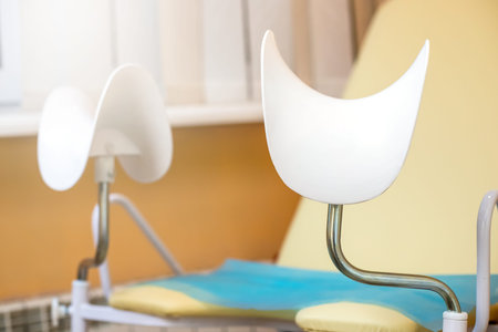 gynecological chair in gynecological office on orange background. Health checkup. Womens Health...