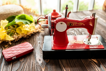Vintage children's sewing machine on a wooden table near the window. Children's Soviet sewing...