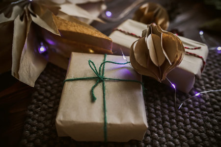 Zero waste Christmas gift. Wrapped by hand gift in New Year Eve. Delivered and balls made of craft...