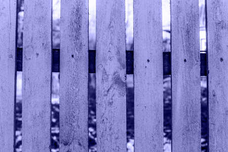 Trendy Color of Year. Very peri. 2022. fence made of wood. Wooden background with weathered wood. rarely nailed planksの写真素材