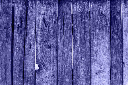 Trendy Color of Year. Very peri. 2022. Wooden fence with boards with peeling paint.の写真素材