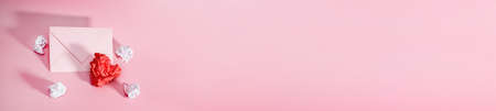 Paper heart and crumpled sheets of paper for writing with a craft envelope.Crumpled sheet of paper in the shape of a heart on a pink background. Valentine's Day, March 8 or declaration of loveの写真素材
