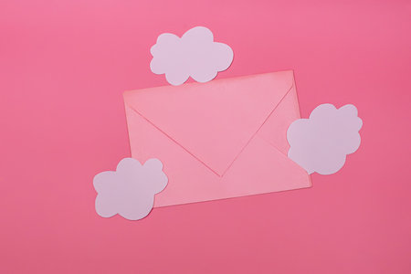 Craft envelope for writing or a declaration of love near white paper-cut clouds