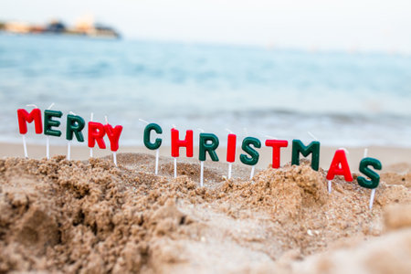 inscription of Merry Christmas on beach. Celebrating Christmas on beach. Vacation at resort in a warm country before New Year.の写真素材