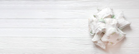 Diapers waste - dirty diapers of baby. Disposing of used baby nappies. used diapers on white wooden background.の写真素材
