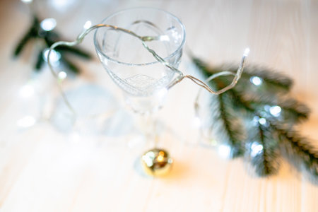 Transparent crystal wineglass with Christmas toys and spruce branches.の写真素材