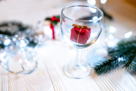 Red tiny surprise gift in a transparent glass for Christmas or New Year 2023の写真素材