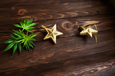 Cannabis leaf on white. Hemp plant in a basket on a white wooden tableの写真素材