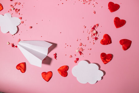 A frame of paper clouds, hearts and a paper airplane for Valentine's Day commercialsの写真素材